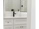 The bathroom has a bright vanity with sleek fixtures and a modern mirror with matching tile at 2327 Mason Dr # D23, Atlanta, GA 30316