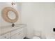 Bathroom with a modern vanity, a stylish wicker mirror, and a clean, white tiled tub shower at 2327 Mason Dr # D23, Atlanta, GA 30316