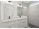 Modern bathroom featuring double vanity, black hardware, and geometric tiled shower at 2327 Mason Dr # D23, Atlanta, GA 30316