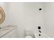 Well-lit bathroom with a white vanity, a round wicker mirror, and tiled tub shower at 2327 Mason Dr # D23, Atlanta, GA 30316
