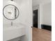 Stylish powder room with a modern round mirror and a sleek floating vanity at 2327 Mason Dr # D23, Atlanta, GA 30316