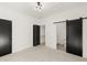 Bright bedroom with modern lighting, carpet, and a sliding barn door to bathroom at 2327 Mason Dr # D23, Atlanta, GA 30316