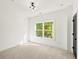 Bright bedroom with plush carpet, neutral walls, and large window offering natural light at 2327 Mason Dr # D23, Atlanta, GA 30316