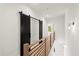 Hallway with a black sliding barn door and hardwood floors at 2327 Mason Dr # D23, Atlanta, GA 30316