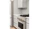 Stainless range with gray cabinets above in this modern kitchen at 2327 Mason Dr # D23, Atlanta, GA 30316