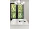 A close up of the stainless sink on the kitchen island, in front of the black framed doors at 2327 Mason Dr # D23, Atlanta, GA 30316