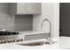 Close up of a stainless sink and faucet on the quartz kitchen island at 2327 Mason Dr # D23, Atlanta, GA 30316