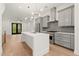 Modern kitchen with stainless steel appliances, kitchen island, pendant lighting, and an exit to the back yard at 2327 Mason Dr # D23, Atlanta, GA 30316
