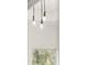 Modern hanging lights with exposed bulbs illuminate this bright and airy room at 2327 Mason Dr # D23, Atlanta, GA 30316