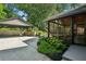 Inviting backyard featuring a detached carport, screened porch, landscaped garden, and concrete patio at 608 Sherwood Ne Rd, Atlanta, GA 30324
