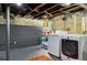 Functional laundry area in basement with washer, dryer, and storage shelves at 608 Sherwood Ne Rd, Atlanta, GA 30324
