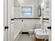 Traditional bathroom features white subway tiles, a black accent stripe, and classic fixtures at 608 Sherwood Ne Rd, Atlanta, GA 30324