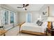 Bright bedroom with a wooden bed frame, neutral walls, and a window with patterned curtains at 608 Sherwood Ne Rd, Atlanta, GA 30324