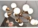 Close up of dining room chandelier with gold and white accents, showing modern lighting details at 608 Sherwood Ne Rd, Atlanta, GA 30324
