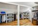 Spacious closet featuring custom shelving, plenty of hanging space, and hardwood floors at 608 Sherwood Ne Rd, Atlanta, GA 30324