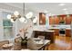 Dining room open to the kitchen features a chandelier and access to modern appliances and countertop seating at 608 Sherwood Ne Rd, Atlanta, GA 30324
