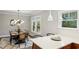 Elegant dining room with modern lighting, a large window, and stylish decor at 608 Sherwood Ne Rd, Atlanta, GA 30324