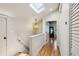 Bright hallway with hardwood floors, stylish lighting, and an open doorway to an inviting space at 608 Sherwood Ne Rd, Atlanta, GA 30324