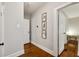Hallway with hardwood floors, neutral paint, and framed botanical wall art at 608 Sherwood Ne Rd, Atlanta, GA 30324
