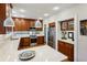 Updated kitchen featuring bar seating, warm wood cabinetry, stainless steel appliances and quartz countertops at 608 Sherwood Ne Rd, Atlanta, GA 30324