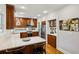 Kitchen features warm wood cabinetry, bar seating, stainless steel appliances, and quartz countertops at 608 Sherwood Ne Rd, Atlanta, GA 30324