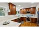 The updated kitchen features warm wood cabinetry, quartz countertops, and stainless steel appliances at 608 Sherwood Ne Rd, Atlanta, GA 30324