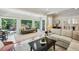 Bright living room featuring large windows with views of backyard greenery and modern furnishings at 608 Sherwood Ne Rd, Atlanta, GA 30324