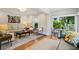 Spacious open living area with a large sofa, accent chairs, and view into the bright sun room at 608 Sherwood Ne Rd, Atlanta, GA 30324