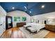 Serene main bedroom with a blue ceiling, hardwood floors, and ample natural light from large windows at 608 Sherwood Ne Rd, Atlanta, GA 30324