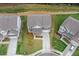 Aerial view of a well-maintained home with landscaped yard and driveway at 6100 Misty Hill Ln, Buford, GA 30518