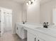 Bright bathroom with double sinks and clean, white cabinets for ample storage at 6100 Misty Hill Ln, Buford, GA 30518