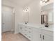 Modern bathroom featuring double sinks, sleek black faucets, and white cabinets for ample storage at 6100 Misty Hill Ln, Buford, GA 30518