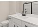 Well-lit bathroom featuring black hardware, quartz countertop, and a glass-enclosed shower at 6100 Misty Hill Ln, Buford, GA 30518