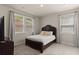 Cozy bedroom with neutral tones, plush carpeting, and natural light from two windows at 6100 Misty Hill Ln, Buford, GA 30518
