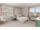 Well-lit bedroom featuring two windows with pink floral wallpaper and accents at 6100 Misty Hill Ln, Buford, GA 30518