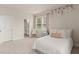 Light-filled bedroom boasts floral accents on the wall and access to a full bathroom at 6100 Misty Hill Ln, Buford, GA 30518