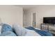 Bright bedroom featuring a decorative TV console and a peek into the ensuite bath at 6100 Misty Hill Ln, Buford, GA 30518