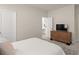 Bright bedroom with a wooden dresser and an ensuite bathroom at 6100 Misty Hill Ln, Buford, GA 30518