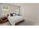 Comfortable bedroom featuring natural light, a bed, and a cozy beanbag chair at 6100 Misty Hill Ln, Buford, GA 30518