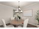 Inviting dining room with elegant lighting, comfortable seating, and neutral decor at 6100 Misty Hill Ln, Buford, GA 30518