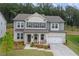 Charming two-story home boasts a well-manicured lawn, neutral colors, and inviting curb appeal at 6100 Misty Hill Ln, Buford, GA 30518