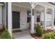 Charming front porch featuring rocking chairs, well-kept landscaping, and a welcoming entrance at 6100 Misty Hill Ln, Buford, GA 30518