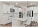 Modern kitchen featuring white cabinets, stainless steel appliances, and a quartz countertop island at 6100 Misty Hill Ln, Buford, GA 30518