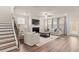 Inviting living room boasts natural light, wood flooring, and a cozy fireplace at 6100 Misty Hill Ln, Buford, GA 30518