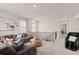 Upstairs living room featuring a sectional couch, large windows and stairway at 6100 Misty Hill Ln, Buford, GA 30518