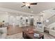 Bright, open-concept living room flows into kitchen with stainless appliances and breakfast bar seating at 6100 Misty Hill Ln, Buford, GA 30518