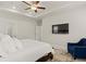 This bedroom features a ceiling fan, TV, and a comfortable blue chair with a decorative rug at 6100 Misty Hill Ln, Buford, GA 30518