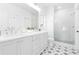 Elegant bathroom with double vanity, quartz countertops, tiled floors, and glass-enclosed shower at 3319 Stillwood Ln, Hapeville, GA 30354