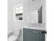 Bathroom featuring a blue vanity with white countertop, white subway tile, and a soaking tub at 3319 Stillwood Ln, Hapeville, GA 30354