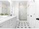 Elegant bathroom with double vanity, quartz countertops, tiled floors, and glass-enclosed shower at 3319 Stillwood Ln, Hapeville, GA 30354